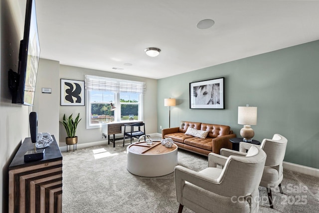 living area with carpet, visible vents, and baseboards