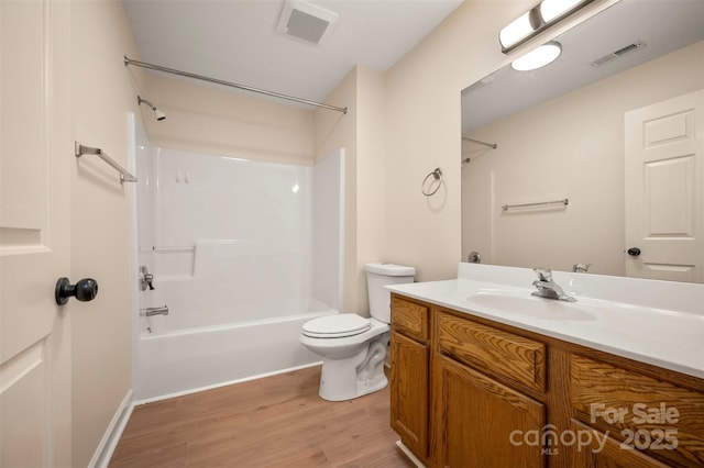 bathroom featuring visible vents, shower / tub combination, wood finished floors, and toilet