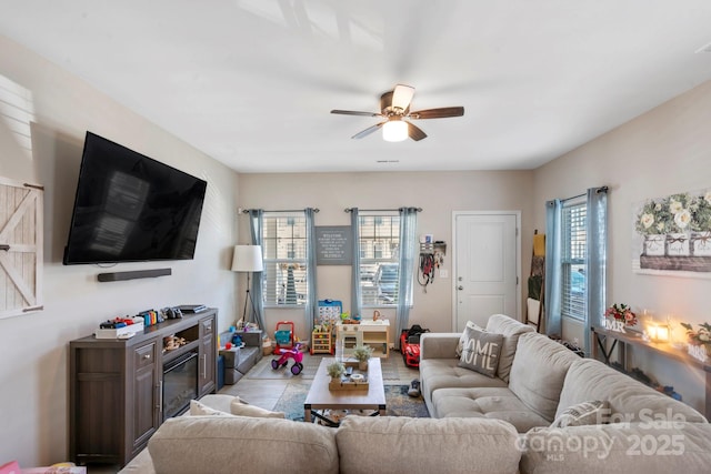 living area featuring plenty of natural light and a ceiling fan