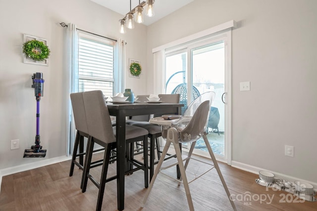 dining room with baseboards and wood finished floors