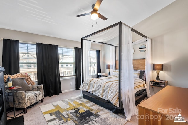 bedroom with baseboards, a ceiling fan, and light colored carpet