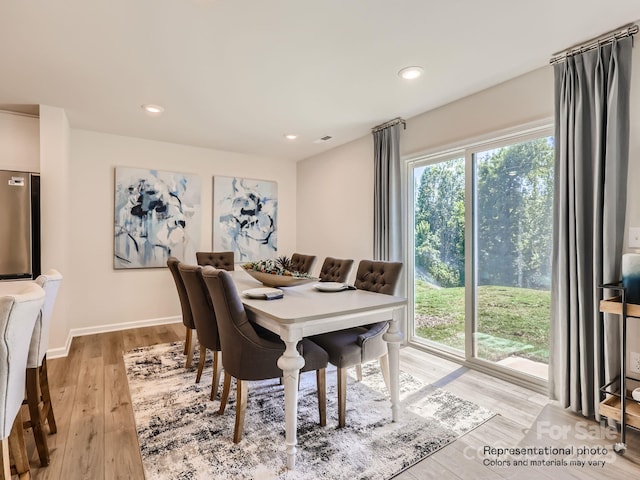 dining area featuring light wood-type flooring, baseboards, and recessed lighting