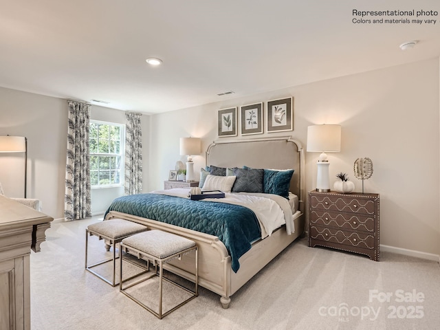 bedroom with light colored carpet, visible vents, and baseboards