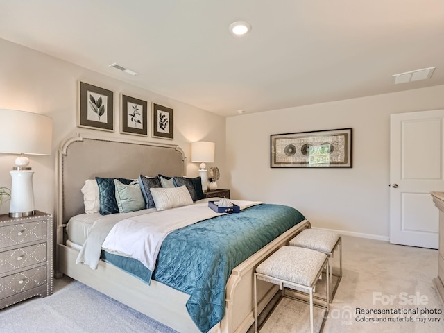 bedroom featuring baseboards, visible vents, and light colored carpet