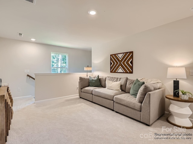 carpeted living area featuring baseboards, visible vents, and recessed lighting