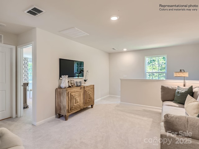 living room with light colored carpet, visible vents, baseboards, and recessed lighting