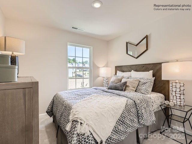 carpeted bedroom with visible vents and baseboards