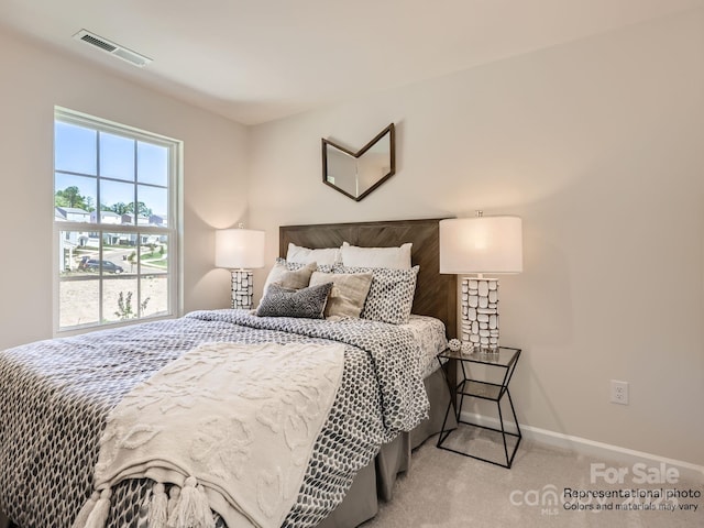 bedroom with baseboards, visible vents, and carpet flooring