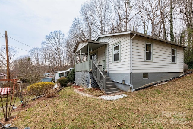 view of front of property with a front lawn, stairway, and a porch