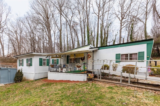 manufactured / mobile home with a porch and a front yard