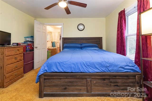 carpeted bedroom featuring multiple windows and ceiling fan