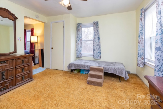 carpeted bedroom with a ceiling fan