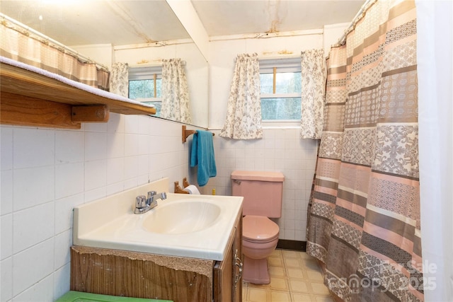 bathroom featuring a wealth of natural light, toilet, tile walls, and tile patterned floors