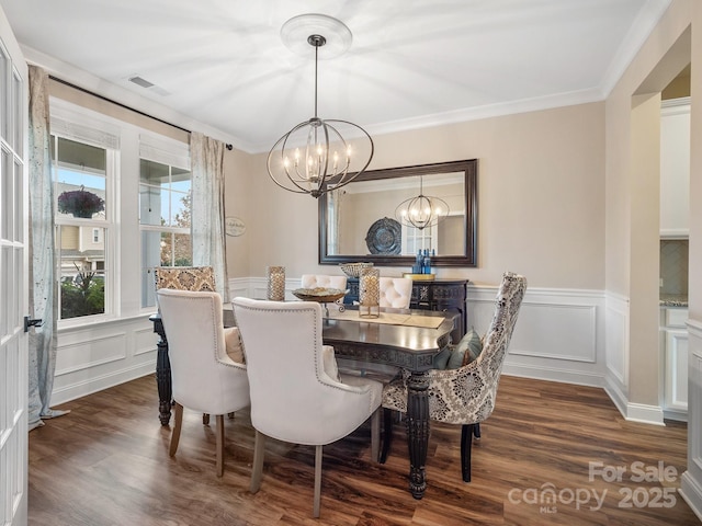 dining space with visible vents, a decorative wall, dark wood finished floors, ornamental molding, and a notable chandelier