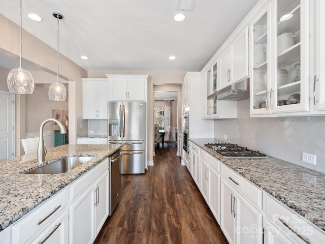 kitchen with dark wood-style flooring, a sink, stainless steel appliances, white cabinets, and under cabinet range hood