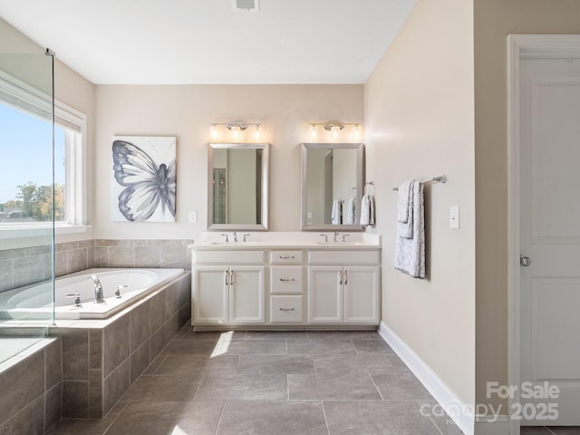 bathroom with double vanity, a bath, baseboards, and a sink