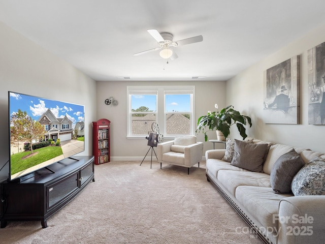 living area with carpet flooring, visible vents, baseboards, and ceiling fan