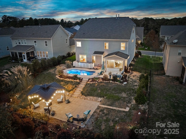 rear view of property featuring a fenced in pool, an outdoor hangout area, a fenced backyard, area for grilling, and a patio