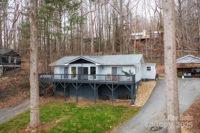 view of front of house featuring a wooden deck and metal roof