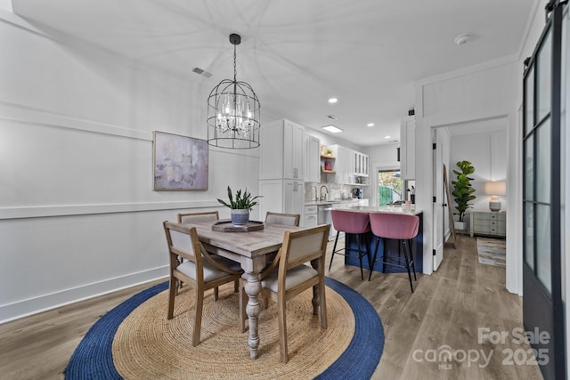 dining area featuring recessed lighting, baseboards, visible vents, and light wood finished floors