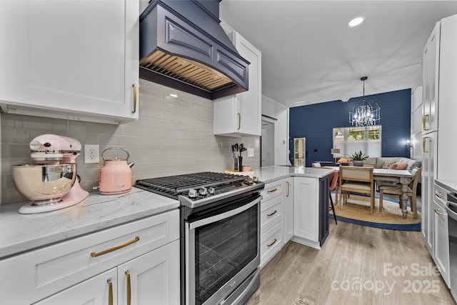 kitchen with light wood-style flooring, gas stove, open floor plan, white cabinetry, and premium range hood