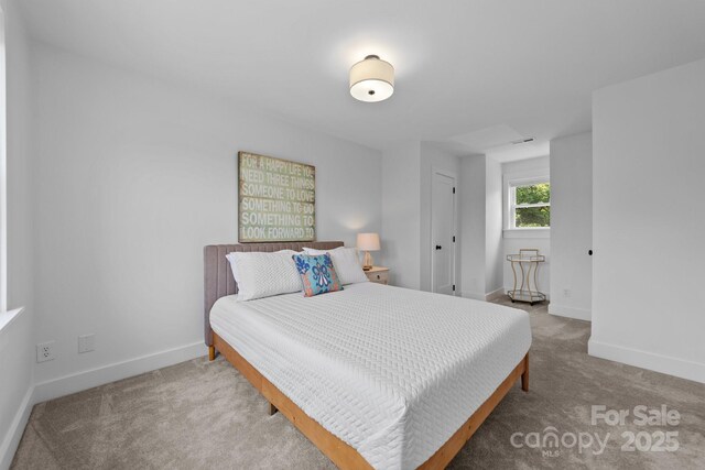 carpeted bedroom featuring baseboards