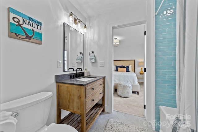 full bathroom with ensuite bathroom, tile patterned flooring, toilet, a shower with shower curtain, and vanity