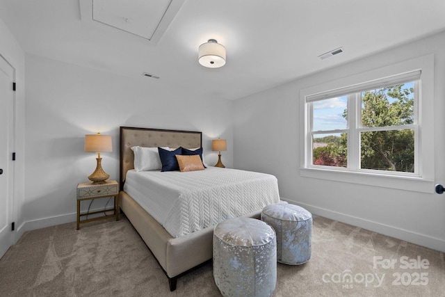 bedroom with carpet floors, attic access, visible vents, and baseboards