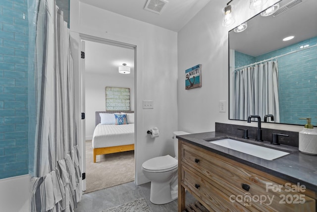 full bathroom with toilet, vanity, and visible vents