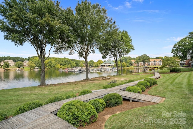 view of community featuring a water view and a yard