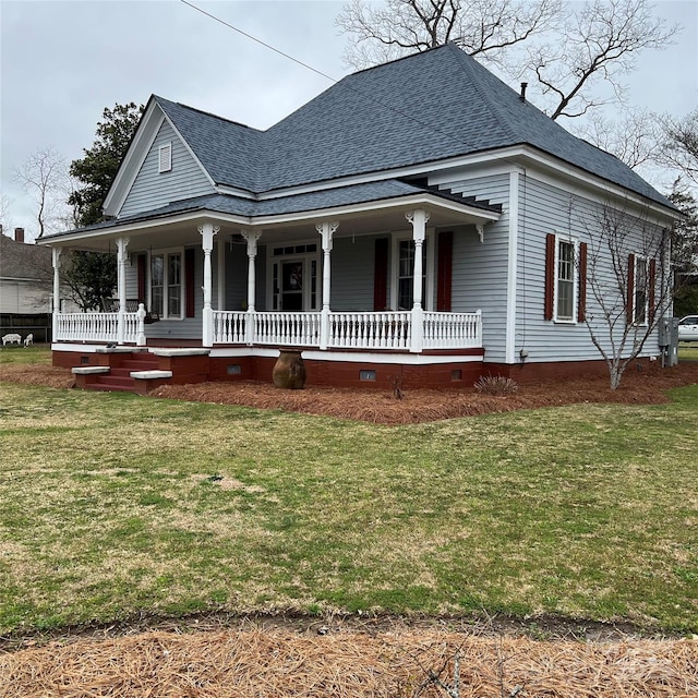 farmhouse inspired home with covered porch, roof with shingles, a front lawn, and crawl space