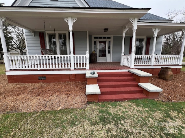 view of front facade with crawl space, covered porch, and roof with shingles