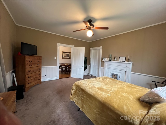 bedroom featuring carpet, ornamental molding, and wainscoting