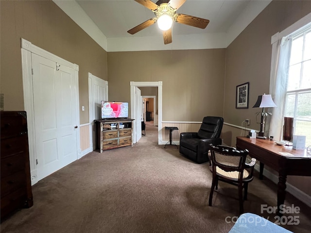 home office with a high ceiling, carpet flooring, and a ceiling fan