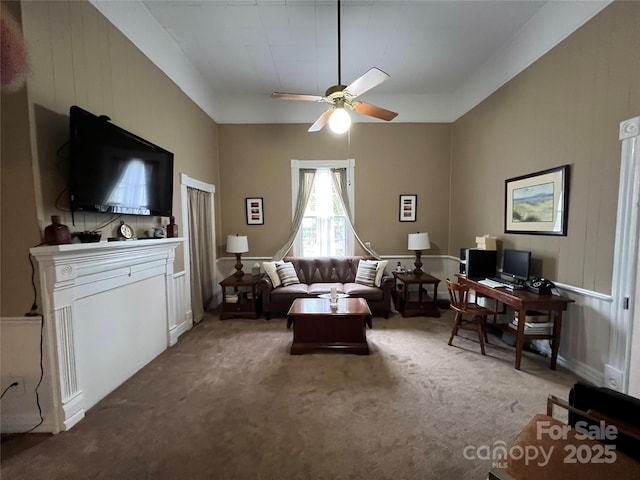 carpeted living room with ceiling fan