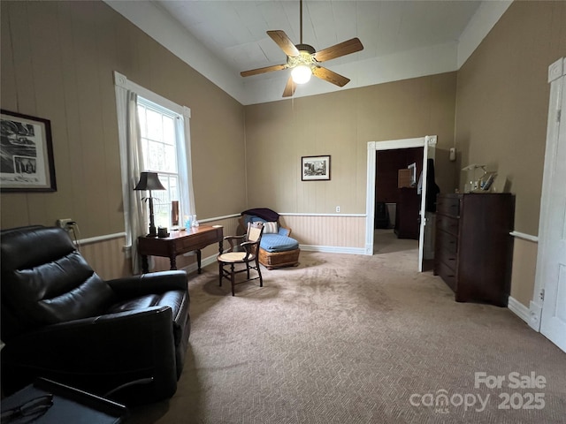 living area with ceiling fan, carpet flooring, and baseboards