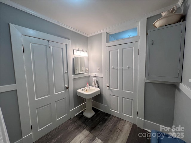 bathroom featuring wood finished floors and crown molding