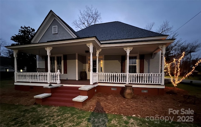 view of front of home featuring a porch, crawl space, and roof with shingles