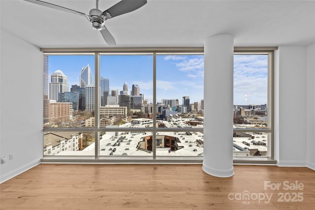 interior space featuring plenty of natural light, a view of city, and a ceiling fan