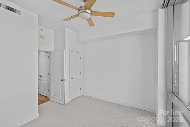 unfurnished bedroom with a ceiling fan, baseboards, visible vents, and carpet flooring