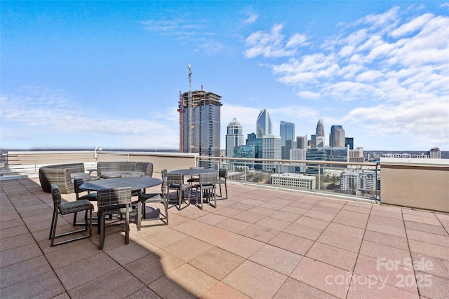 view of patio / terrace featuring outdoor dining area and a city view