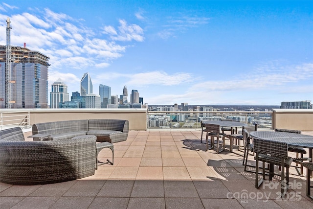 view of patio / terrace featuring a view of city and an outdoor living space