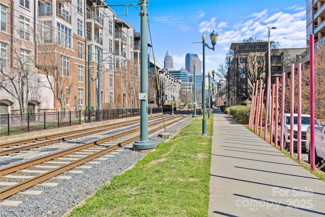 view of community featuring a city view and fence