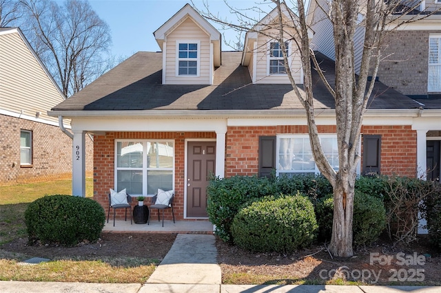 view of front facade featuring covered porch and brick siding