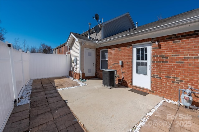 view of patio with a fenced backyard and central air condition unit