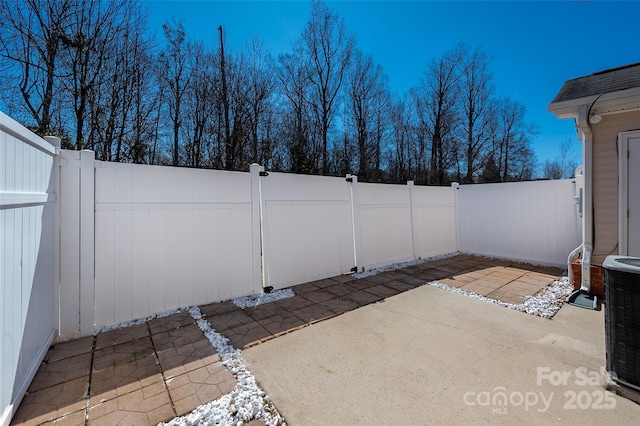 view of patio / terrace featuring cooling unit and a fenced backyard