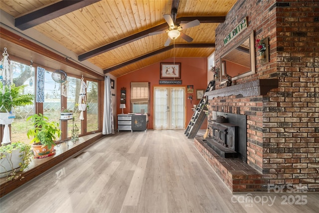 unfurnished living room featuring lofted ceiling with beams, wooden ceiling, wood finished floors, and french doors