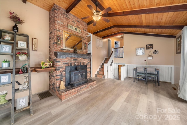 living room with vaulted ceiling with beams, wood finished floors, and wood ceiling