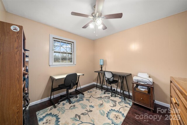 home office featuring a ceiling fan, baseboards, and wood finished floors