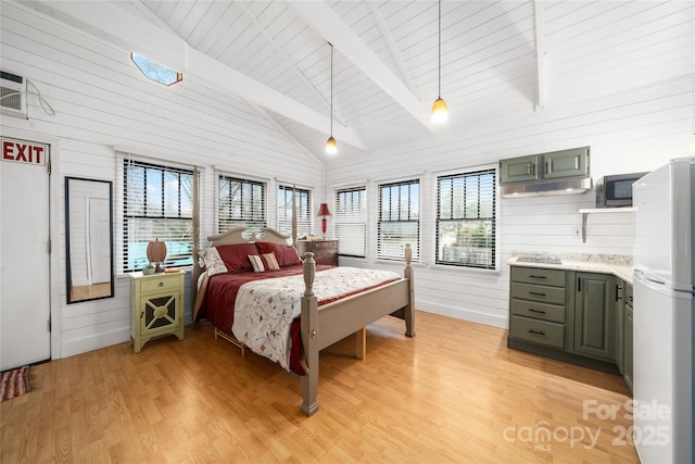 bedroom featuring beam ceiling, freestanding refrigerator, wood walls, light wood-type flooring, and wooden ceiling